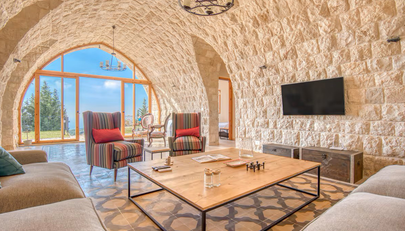 Vaulted stone salon of a private villa built by EJI Interiors overlooking the Lebanese mountains