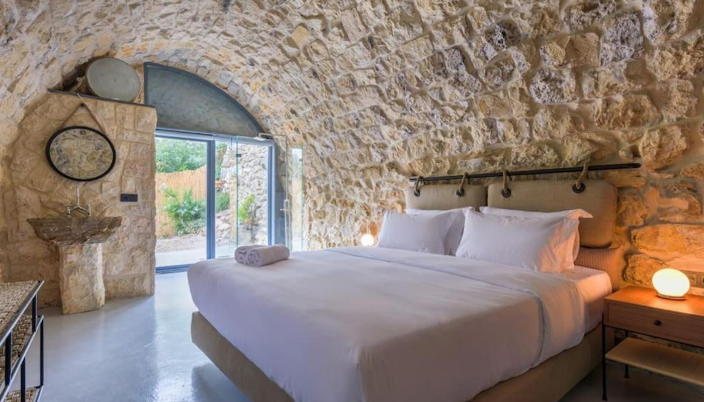 Stone vaulted bedroom in a villa built by EJI Interiors